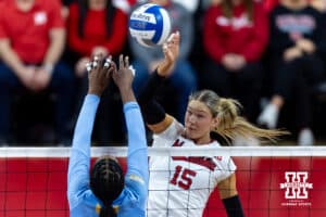 Nebraska Cornhusker middle blocker Andi Jackson (15) spikes the ball against LIU Shark middle blocker Yasmeen Muhammad (15) during the first round of the NCAA volleyball tournament on Friday, Dec. 5, 2025, in Lincoln, Nebraska. Photo by John S. Peterson.