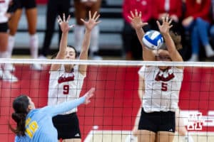 Nebraska Cornhusker middle blocker Rebekah Allick (5) and opposite Virginia Adriano (9) block the ball against LIU Shark outside hitter Sara van Gisteren (18) during the first round of the NCAA volleyball tournament on Friday, Dec. 5, 2025, in Lincoln, Nebraska. Photo by John S. Peterson.