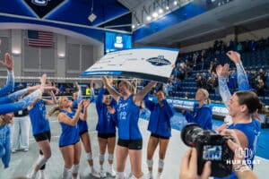 Creighton Bluejay Ava TeStrake (12) raises the bracket after a volleyball match game against Northern Iowa on Thursday, Dec 5, 2025, in Omaha, Nebraska. Photo by Brandon Tiedemann.
