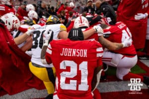 Nebraska Cornhusker running back Emmett Johnson (21) kneels down for a prayer after the game with Iowa Hawkeyes on Friday, Nov. 28, 2025, in Lincoln, Nebraska. Photo by John S. Peterson.