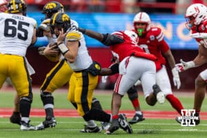 Nebraska Cornhusker linebacker Marques Watson-Trent (33) reaches out to tackle Iowa Hawkeye quarterback Mark Gronowski (11) during a college football game on Friday, Nov. 28, 2025, in Lincoln, Nebraska. Photo by John S. Peterson.