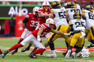 Nebraska Cornhusker defensive back Donovan Jones (37) lunges towards Iowa Hawkeye running back Nathan McNeil (25) to make the tackle during a college football game on Friday, Nov. 28, 2025, in Lincoln, Nebraska. Photo by John S. Peterson.