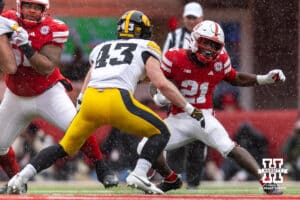 Nebraska Cornhusker running back Emmett Johnson (21) makes a cut running with the ball against Iowa Hawkeye linebacker Karson Sharar (43) during a college football game on Friday, Nov. 28, 2025, in Lincoln, Nebraska. Photo by John S. Peterson.
