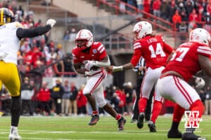 Nebraska Cornhusker quarterback TJ Lateef (14) hands the ball off to running back Emmett Johnson (21) against the Iowa Hawkeyes during a college football game on Friday, Nov. 28, 2025, in Lincoln, Nebraska. Photo by John S. Peterson.