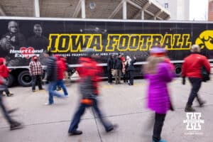 Nebraska Cornhuskers pose for photos in front of the Iowa equipment truck as fans walk by before a college football game against the Iowa Hawkeyes on Friday, Nov. 28, 2025, in Lincoln, Nebraska. Photo by John S. Peterson.