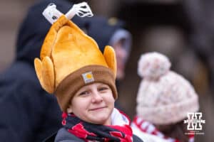Nebraska Cornhusker fan walks over to the stadium with a turkey hat a day after Thanksgiving for a college football game against the Iowa Hawkeyes on Friday, Nov. 28, 2025, in Lincoln, Nebraska. Photo by John S. Peterson.