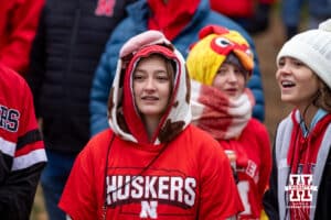 Nebraska Cornhusker fans listen to the Cornhusker Marching Band warm up before heading over to the stadium for a college football game against the Iowa Hawkeyes on Friday, Nov. 28, 2025, in Lincoln, Nebraska. Photo by John S. Peterson.