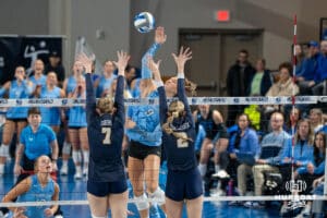 Creighton Bluejay Ava Martin (8) hits through defenders during a volleyball match game against Northern Colorado on Thursday, Dec 4, 2025, in Omaha, Nebraska. Photo by Brandon Tiedemann.