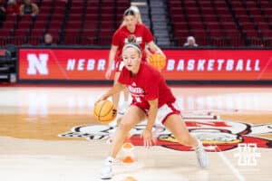 Nebraska Cornhusker guard Callin Hake (14) leads the dribbling warm up before taking on Bradley Braves during a college basketball game on Wednesday, Dec. 3, 2025, in Lincoln, Nebraska. Photo by John S. Peterson.