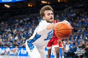 Creighton Bluejay Owen Freeman (32) reaches for a loose ball during a college basketball game against Nicholls on Tuesday, Dec 2, 2025, in Omaha, Nebraska. Photo by Brandon Tiedemann.