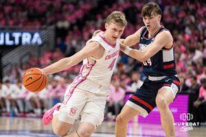 Creighton Bluejay Josh Dix (4) drives past Braylon Mullins (24) during a college basketball game against UCONN on Jan 31, 2026, in Omaha, Nebraska. Photo by Brandon Tiedemann