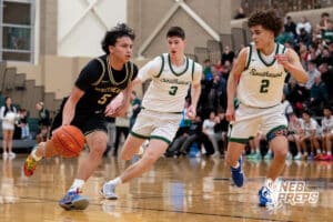 Lincoln Southeast Knight Jayvis Johnson (5) tries to move around Lincoln Southwest's Crayton Meyer (3) and Uzziah Sanders (3) during a high school basketball game, Thursday, Jan. 29, 2026, Lincoln, Nebraska. Photo by Braden Cochran.