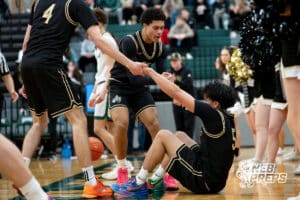 Lincoln Southeast players Gavin Kubik (4) and Rowan Lambert (0) help Jayvis Johnson (5) off of the court floor against Lincoln Southwest during a high school basketball game, Thursday, Jan. 29, 2026, Lincoln, Nebraska. Photo by Braden Cochran.