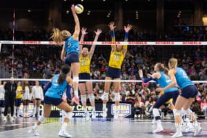Omaha Supernovas Brooke Nuneviller (5) spikes the ball against San Diego Mojo Marlie Monserez (21) and McKenna Vicini (14) in the first set during a professional volleyball match Friday, Jan. 30, 2026, in Omaha, Nebraska. Photo by John S. Peterson.