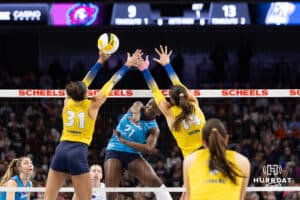 Omaha Supernovas Toyosi Onabanjo (21) spikes the ball past San Diego Mojo Maya Tabron (31) and McKenna Vicini (14) in the first set during a professional volleyball match Friday, Jan. 30, 2026, in Omaha, Nebraska. Photo by John S. Peterson.
