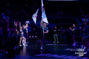 The Supernovas spirit squad member leads the team out with a Supernovas flag before taking on the San Diego Mojo during a professional volleyball match on Friday, Jan. 30, 2026, in Omaha, Nebraska. Photo by John S. Peterson.