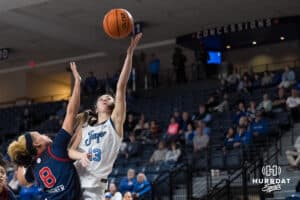 Creighton Bluejay Allison Heathcock (13) shoots over Shaulana Wagner (8)during a college basketball game against St. John’s on Jan 28, 2026, in Omaha, Nebraska. Photo by Brandon Tiedemann