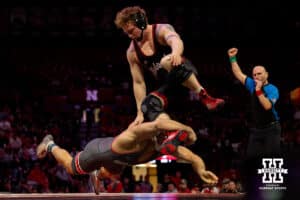 At 197, Nebraska wrestler Camden McDanel leaps over Ohio State Buckeye during a college wrestling dual Sunday, Jan. 25, 2026, Lincoln, Nebraska. Photo by Braden Cochran.