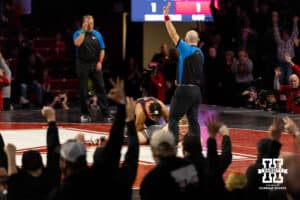 An energetic Husker crowd signals a three point takedown as Nebraska wrestler Christopher Minto takes down Ohio State wrestler Carson Kharchla in sudden victory to win the bout during a college wrestling dual Sunday, Jan. 25, 2026, Lincoln, Nebraska. Photo by Braden Cochran.