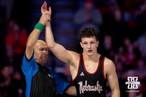 At 165, Nebraska Cornhusker Lj Arujo has his hand raised in victory during a college wrestling dual Sunday, Jan. 25, 2026, Lincoln, Nebraska. Photo by Braden Cochran.