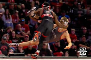 At 157, Ohio State Buckeye Maddox Shaw has his legs swept out from underneath him by Nebraska Cornhusker Antrell Taylor during a college wrestling dual Sunday, Jan. 25, 2026, Lincoln, Nebraska. Photo by Braden Cochran.