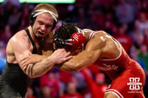 At 174, Nebraska Cornhusker Christopher Minto tries to push through against Iowa Hawkeye Patrick Kennedy during a college wrestling dual Friday, Jan. 23, 2026, Lincoln, Nebraska. Photo by Braden Cochran.