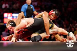 At 174, Nebraska Cornhusker Christopher Minto attempts to wrap up Iowa Hawkeye Patrick Kennedy during a college wrestling dual Friday, Jan. 23, 2026, Lincoln, Nebraska. Photo by Braden Cochran.