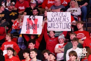 Nebraska Cornhusker fans hold up signs during a college wrestling dual against the Iowa Hawkeye on Friday, Jan. 23, 2026, Lincoln, Nebraska. Photo by Braden Cochran.