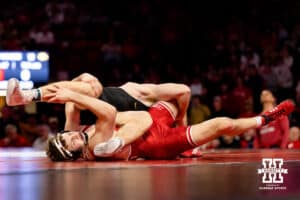 At 165, Nebraska Cornhusker LJ Araujo fights to control the leg of Iowa Hawkeye Mikey Caliendo during a college wrestling dual on Friday, Jan. 23, 2026, Lincoln, Nebraska. Photo by Braden Cochran.