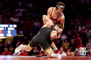 At 165, Nebraska Cornhusker LJ Araujo fights to keep his balance against Iowa Hawkeye Mikey Caliendo during a college wrestling dual on Friday, Jan. 23, 2026, Lincoln, Nebraska. Photo by Braden Cochran.