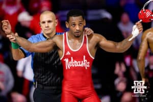 At 157, Nebraska Cornhusker Antrell Taylor has his arm raised in victory during a college wrestling dual Friday, Jan. 23rd, 2026, Lincoln, Nebraska. Photo by Braden Cochran.
