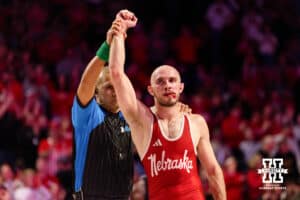 At 141, Nebraska Cornhusker Brock Hardy has his hand raised in the air after winning his 100th match during a college wrestling dual against Nasir Bailey on Friday, Jan. 23, 2026, Lincoln, Nebraska. Photo by Braden Cochran.