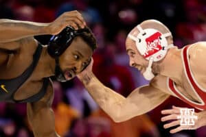 At 141, Nebraska Cornhusker Brock Hardy smiles as he creates space with Iowa Hawkeye Nasir Bailey during a college wrestling dual Friday, Jan. 23, 2026, Lincoln, Nebraska. Photo by Braden Cochran.