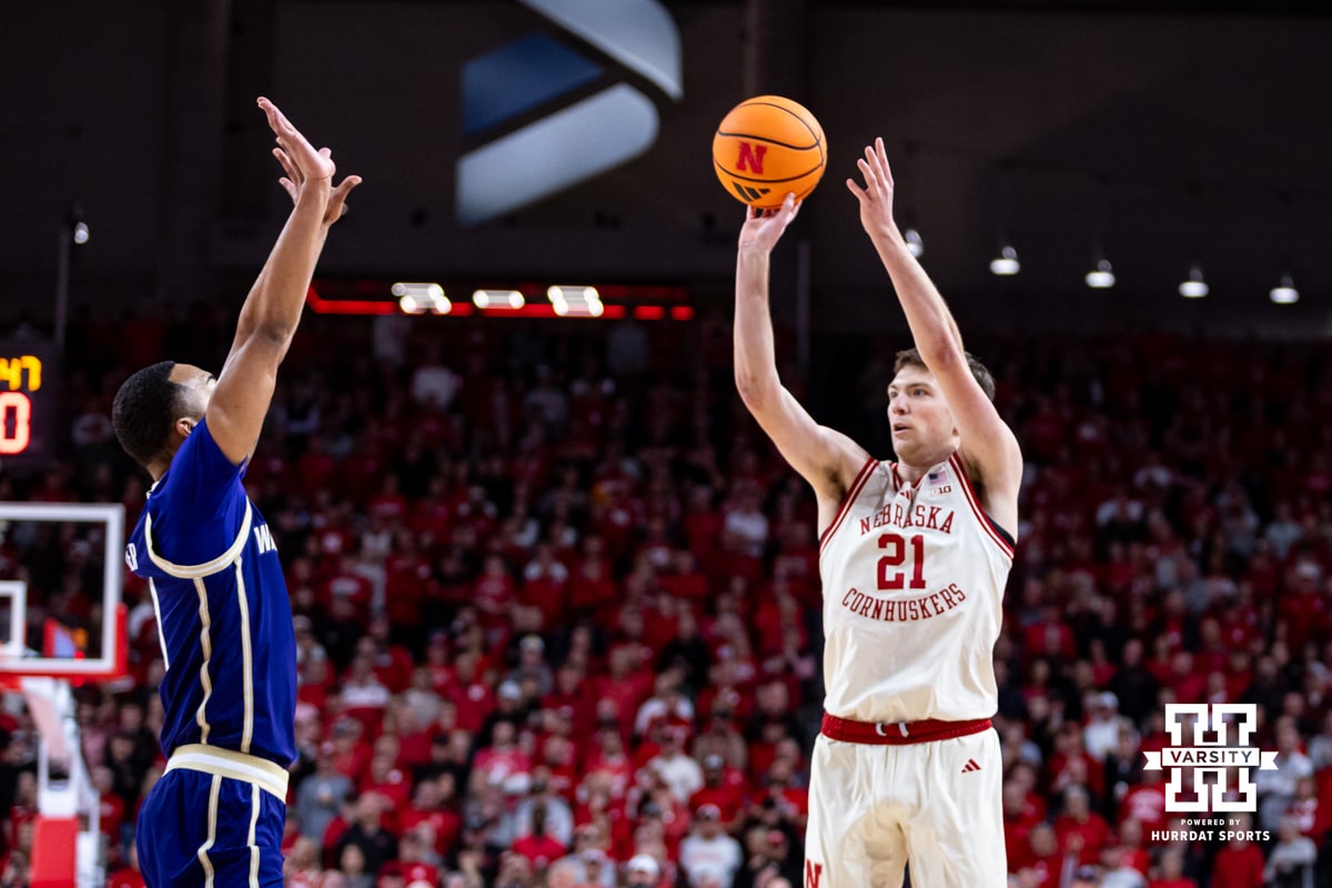 Nebraska Cornhusker forward Pryce Sandfort (21) makes a three point shot against Washington Husky forward Bryson Tucker (8) in the first half during a college men’s basketball game Wednesday, Jan. 21, 2026, in Lincoln, Nebraska. Photo by John S. Peterson.