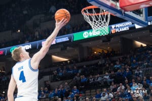 Creighton Bluejay Josh Dix (4) stretches out for a lay up during a college basketball game against Xavier on Jan 21, 2026, in Omaha, Nebraska. Photo by Brandon Tiedemann