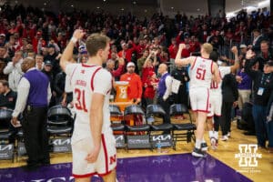 Nebraska Cornhuskers guard Cale Jacobsen (31), forward Rienk Mast (51) and guard Jamarques Lawrence (10) raise their fists in victory to a crowd of Nebraska Cornhuskers fans after a college basketball game against the Northwestern Wildcats on Saturday, Jan. 17, 2026, in Evanston, Illinois. Nebraska Cornhuskers defeated Northwestern Wildcats 77-58. Photo by Kayla Wolf.