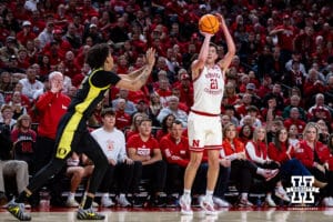 Nebraska Cornhusker forward Pryce Sandfort (21) makes a three point shot against Oregon Duck forward Devon Pryor (22) in the first half during a college men’s basketball game on Tuesday, Jan. 13, 2026, in Lincoln, Nebraska. Photo by John S. Peterson.