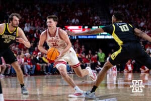 Nebraska Cornhusker forward Pryce Sandfort (21) drives the lane against Oregon Ducks center Nate Bittle (32) and forward Kwame Evans Jr. (10) in the first half during a college men’s basketball game on Tuesday, Jan. 13, 2026, in Lincoln, Nebraska. Photo by John S. Peterson.