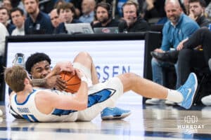 Creighton Bluejay Isaac Traudt (41) and KJ Lewis (5) dive for a loose ball during a college basketball game against Georgetown on Jan 13, 2026, in Omaha, Nebraska. Photo by Brandon Tiedemann