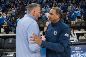 Creighton Bluejay head coach Greg McDermott and Georgetown Hoyas head coach Ed Cooley chat before a college basketball game on Jan 13, 2026, in Omaha, Nebraska. Photo by Brandon Tiedemann
