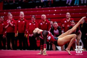 Nebraska Cornhusker Whitney Jenks poses in her floor routine with teammates cheering her on during the Ameritas Master’s Classic women's gymnastic meet on Saturday, Jan. 10, 2026, in Lincoln, Nebraska. Photo by Braden Cochran.