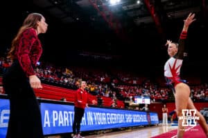 Nebraska Cornhusker Reese Baechle performs on the floor with assistant coach Montana Rall motivating her during the Ameritas Master’s Classic women's gymnastic meet on Saturday, Jan. 10, 2026, in Lincoln, Nebraska. Photo by Braden Cochran.