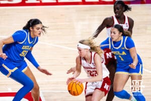 Nebraska Cornhusker guard Britt Prince (23) drives the lane against UCLA Bruin center Lauren Betts (51) and guard Kiki Rice (1) in the third quarter during a college women’s basketball game on Sunday, Jan. 11, 2026, in Lincoln, Nebraska. Photo by John S. Peterson.