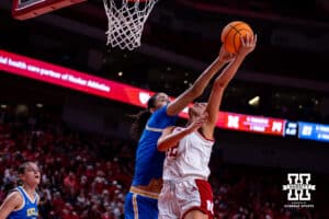 Nebraska Cornhusker forward Jessica Petrie (12) gets blocked by UCLA Bruin center Lauren Betts (51) reach in the first half during a college women’s basketball game on Sunday, Jan. 11, 2026, in Lincoln, Nebraska. Photo by John S. Peterson.