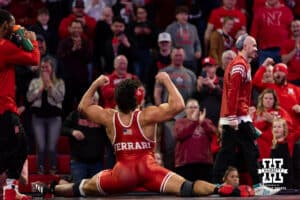 At HWT: #4 Nebraska Cornhusker AJ Ferrari celebrates the win doing the splits against Hayden Filipovich, Ferrari wins by major decision 11-2 during a college wrestling match on Friday, Jan. 9, 2026, in Lincoln, Nebraska. Photo by John S. Peterson.