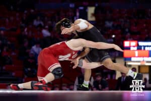 At 197: #12 Nebraska Cornhusker Camden McDanel shoots for a leg against #23 Purdue Boilermaker Ben Vanadia, McDanel win 7-1 during a college wrestling match on Friday, Jan. 9, 2026, in Lincoln, Nebraska. Photo by John S. Peterson.