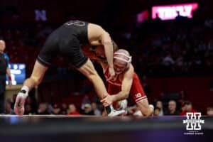 At 141: #3 Nebraska Cornhusker Brock Hardy grabs the ankle for a takedown against Purdue Boilermaker Vincent Paino, Hardy wins by pin in 3:54, during a college wrestling match on Friday, Jan. 9, 2026, in Lincoln, Nebraska. Photo by John S. Peterson.