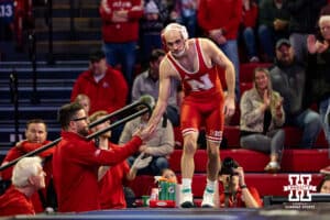 At 141: #3 Nebraska Cornhusker Brock Hardy gives five to assistant coach Bryan Snyder before taking on Purdue Boilermaker Vincent Paino during a college wrestling match on Friday, Jan. 9, 2026, in Lincoln, Nebraska. Photo by John S. Peterson.