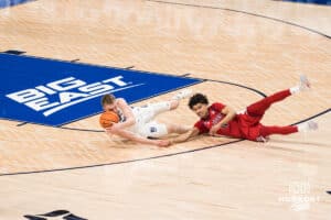 Creighton Bluejay Josh Dix (4) dives for a lose ball during a college basketball game against St. John’s on Jan 10, 2026 in Omaha, Nebraska. Photo by Brandon Tiedemann