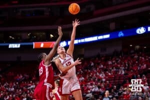 Nebraska Cornhusker forward Jessica Petrie (12) makes a lay up against Indiana Hoosier forward Zania Socka-Nguemen (23) during a college women’s basketball game on Thursday, Jan. 8, 2026, in Lincoln, Nebraska. Photo by John S. Peterson.